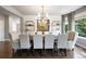 Sophisticated dining room with hardwood floors, decorative lighting, and seating for ten at 6175 Puma Sands, Lone Tree, CO 80124