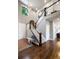 Grand foyer with hardwood floors, staircase, large window, and chandelier at 6175 Puma Sands, Lone Tree, CO 80124
