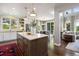 Open concept kitchen with an island and seamless flow into the living and dining areas at 6175 Puma Sands, Lone Tree, CO 80124