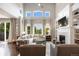 Spacious living room featuring a fireplace, built-in shelving, and large windows with outdoor views at 6175 Puma Sands, Lone Tree, CO 80124
