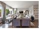 Bright living room with neutral colors, large windows, and a relaxing seating arrangement at 6175 Puma Sands, Lone Tree, CO 80124