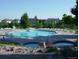 Community pool with ample lounge seating and a separate jacuzzi, perfect for relaxation at 6175 Puma Sands, Lone Tree, CO 80124