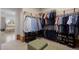 Organized walk-in closet with ample hanging space, shelves, and shoe storage at 6175 Puma Sands, Lone Tree, CO 80124