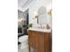 Modern bathroom with a wooden vanity, marble countertop, and gold fixtures at 448 Brook Rd, Evergreen, CO 80439