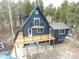 A-frame home with large deck and mountain views in snowy landscape at 448 Brook Rd, Evergreen, CO 80439