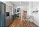 Stylish kitchen featuring stainless steel appliances, wood countertops, and dining area with chairs at 1103 Lipan St, Denver, CO 80204
