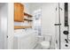 Bright laundry area features a side by side washer and dryer, storage and a decorative glass block window at 1103 Lipan St, Denver, CO 80204