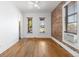 Bright living room with hardwood floors, exposed brick and large windows offering a neighborhood view at 1103 Lipan St, Denver, CO 80204