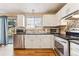 Kitchen features stainless steel appliances and white cabinets at 8773 W Star Dr, Littleton, CO 80128