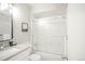 Bathroom featuring granite countertop and shower with glass door at 3855 S Monaco St # 208, Denver, CO 80237