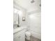 Bathroom featuring granite countertop and shower with glass door at 3855 S Monaco St # 208, Denver, CO 80237