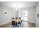 Bright dining area with modern lighting, table with seating, and sliding door access at 3855 S Monaco St # 208, Denver, CO 80237