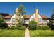 Charming townhouse exterior with brick chimney and well-maintained landscaping at 3855 S Monaco St # 208, Denver, CO 80237