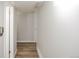 Hallway with wood-look floors, neutral walls, and access to rooms at 3855 S Monaco St # 208, Denver, CO 80237