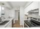 Updated kitchen featuring stainless steel appliances, white cabinets, and granite countertops at 3855 S Monaco St # 208, Denver, CO 80237