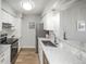 Well-lit kitchen with granite countertops, stainless steel appliances, and white cabinetry at 3855 S Monaco St # 208, Denver, CO 80237