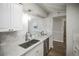Stylish kitchen featuring granite countertops, stainless steel sink, and modern lighting at 3855 S Monaco St # 208, Denver, CO 80237
