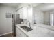 Updated kitchen with stainless steel appliances and granite counters with open breakfast bar at 3855 S Monaco St # 208, Denver, CO 80237