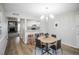 Open-concept living area with modern lighting, dining area, and cozy fireplace at 3855 S Monaco St # 208, Denver, CO 80237