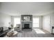 Bright living room featuring a brick fireplace, large windows, and modern decor at 3855 S Monaco St # 208, Denver, CO 80237
