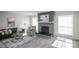 Inviting living room with decorative fireplace, ample natural light, and stylish furnishings at 3855 S Monaco St # 208, Denver, CO 80237
