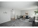Cozy living room with plush carpet, comfortable seating, and neutral decor at 3855 S Monaco St # 208, Denver, CO 80237