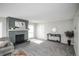 Spacious living room with brick fireplace, console table, and hardwood floors at 3855 S Monaco St # 208, Denver, CO 80237