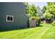 View of a spacious, grassy backyard. Features home's siding and window at 4248 Corriente Pl, Boulder, CO 80301