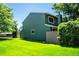 View of the home's side and backyard, with lush green grass at 4248 Corriente Pl, Boulder, CO 80301
