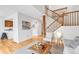 Open living area with hardwood floors, staircase, and kitchen view at 4248 Corriente Pl, Boulder, CO 80301