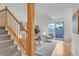 Sunlit living room with a staircase and sliding door access to the backyard at 4248 Corriente Pl, Boulder, CO 80301