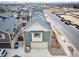 Aerial view of the home displaying garage, neutral siding, and well-manicured landscaping at 13615 E 103Rd Ave, Commerce City, CO 80022