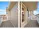 View of the wood deck that accesses the exterior of the home at 13615 E 103Rd Ave, Commerce City, CO 80022