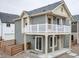 Charming two-story home with a second story balcony and neutral gray siding at 13615 E 103Rd Ave, Commerce City, CO 80022
