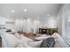 Cozy living room with a comfortable white sofa, stylish decor, and plenty of natural light at 13615 E 103Rd Ave, Commerce City, CO 80022
