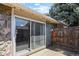 Back patio showcasing sliding glass doors and a view of the backyard with a wooden fence at 2246 N Coronado Pkwy # A, Denver, CO 80229