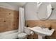 Bathroom featuring earth-toned tiling, a pedestal sink, and a shower/tub combination at 2246 N Coronado Pkwy # A, Denver, CO 80229