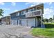Building exterior featuring individual garage bays and a second story balcony at 2246 N Coronado Pkwy # A, Denver, CO 80229