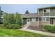 Well maintained townhome with stone accents, grassy lawn, and mature landscaping at 2246 N Coronado Pkwy # A, Denver, CO 80229