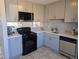 Updated kitchen featuring stainless steel appliances, sleek countertops, and modern gray cabinetry at 2246 N Coronado Pkwy # A, Denver, CO 80229