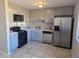 Updated kitchen featuring stainless steel appliances, sleek countertops, and modern gray cabinetry at 2246 N Coronado Pkwy # A, Denver, CO 80229