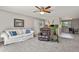 Cozy living room featuring neutral walls, a comfortable sofa, and a ceiling fan at 2246 N Coronado Pkwy # A, Denver, CO 80229