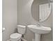 Well-lit half bathroom features a stylish pedestal sink and modern fixtures at 3672 S Perth Cir # 101, Aurora, CO 80013