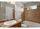 The bathroom features a sink and a tiled shower-tub combination, lit by an overhead light and a window at 3672 S Perth Cir # 101, Aurora, CO 80013