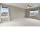 Expansive bedroom with large windows and ceiling fan, offering comfort and ample natural light at 3672 S Perth Cir # 101, Aurora, CO 80013
