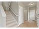 Bright entryway with staircase and tile flooring offers a welcoming space into the home at 3672 S Perth Cir # 101, Aurora, CO 80013