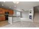 Open-concept kitchen and living area, featuring a granite island and cozy fireplace at 3672 S Perth Cir # 101, Aurora, CO 80013