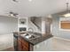 Open kitchen with a granite island, stainless steel appliances, and modern lighting at 3672 S Perth Cir # 101, Aurora, CO 80013