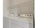 The laundry room featuring a stacked washer and dryer unit, maximizing space and convenience at 3672 S Perth Cir # 101, Aurora, CO 80013