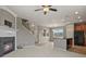 Open living space with fireplace, staircase, and a partial kitchen view, perfect for modern living at 3672 S Perth Cir # 101, Aurora, CO 80013
